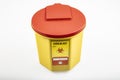 Medical waste bin 1,3 liter. Yellow biohazard medical contaminated clinical waste container isolated on white background Royalty Free Stock Photo