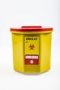 Medical waste bin 1,3 liter. Yellow biohazard medical contaminated clinical waste container isolated on white background Royalty Free Stock Photo