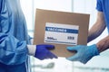 medical worker accepting box delivery of vaccines from courier Royalty Free Stock Photo