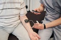 Doctor pressing manual muscle testing device to patient arm