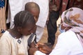 Medical worker doing routine immunization vaccination for children under 9 years, in refugee camp in Africa