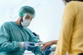 Medical worker examining oxygenation to female patient with new oximeter device during corona virus