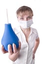 Medical worker holding a blue enema in her hands