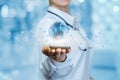 A medical worker is holding a mobile phone with the global map flying above surrounded by small molecules . Royalty Free Stock Photo