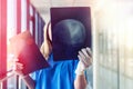 Medical worker looks at xray film of the skull to detect signs of the disease Royalty Free Stock Photo