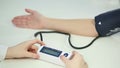 Medical worker monitoring blood pressure of patient diagnosed with hypotension