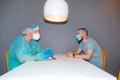Medical worker and patient sitting in a modern hospital room Royalty Free Stock Photo