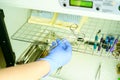 A medical worker puts a medical instrument in a device for disinfection and cleaning of germs. Stylishness and cleanliness in