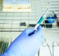 A medical worker puts a medical instrument in a device for disinfection and cleaning of germs. Stylishness and cleanliness in