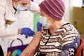 A medical worker in a shopping center inoculates an elderly woman with the COVID-19 vaccine in Chelyabinsk, April 03, 2021.