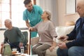 Medical worker taking care of elderly woman in hospice Royalty Free Stock Photo