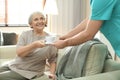 Medical worker taking care of woman in geriatric hospice