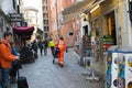 Medical worker is urging to a patient. Streets of Italian town