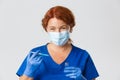 Medical workers, covid-19 pandemic, coronavirus concept. Close-up of smiling kind female doctor in face mask and rubber