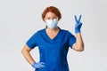 Medical workers, covid-19 pandemic, coronavirus concept. Happy smiling redhead female doctor, nurse staying positive Royalty Free Stock Photo