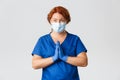 Medical workers, covid-19 pandemic, coronavirus concept. Hopeful female doctor, redhead physician or nurse asking for