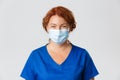 Medical workers, covid-19 pandemic, coronavirus concept. Smiling cheerful female doctor, middle-aged nurse in face mask Royalty Free Stock Photo