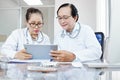Medical workers discussing data on tablet computer Royalty Free Stock Photo