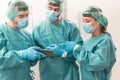 Medical workers using mobile phone inside hospital corridor during coronavirus outbreak - Doctor and nurse at work on Covid-19 Royalty Free Stock Photo