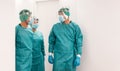 Medical workers walking inside hospital corridor during coronavirus pandemic outbreak - Doctor and nurse at work on Covid-19 Royalty Free Stock Photo