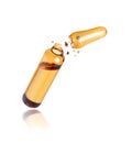 Medical yellow ampoule crushed in the air isolated on a white background