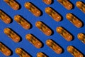 Pattern of yellow transparent liquid capsules with granules on a blue background. Royalty Free Stock Photo