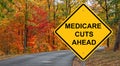 Medicare Cuts Ahead Caution Sign - Autumn Background