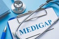 Medicare Supplement Insurance Medigap application and stethoscope.