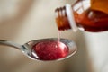 Medication or antipyretic syrup and spoon