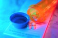 Medication bottle with pills neon glow