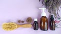 Medication bottles, hairbrush with lost hair and herb heather on purple background. Hair loss problem.