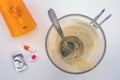 Medication during breakfast, capsules next to a glass of coffee, conceptual image Royalty Free Stock Photo