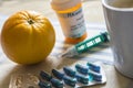 Medication during breakfast, capsules next to a glass of water, conceptual image Royalty Free Stock Photo