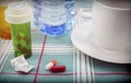 Medication during breakfast, capsules next to a glass of water, conceptual image Royalty Free Stock Photo