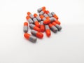 Medication and healthcare concept. Many gray-orange capsules of