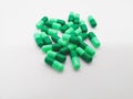 Medication and healthcare concept. Many green capsules of Cephalexin 500 mg. isolated on white background, used to treat serious Royalty Free Stock Photo