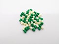 Medication and healthcare concept. Many white-green capsules of Royalty Free Stock Photo