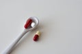 medication pills inside ceramic spoons. drugs, antibiotics, analgesics, narcotics
