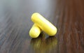 Two yellow pills lie on the table Royalty Free Stock Photo