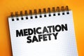 Medication Safety text quote on notepad, health concept background