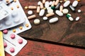 Medications and tablets on a wooden texture table Royalty Free Stock Photo