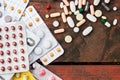 Medications and tablets on a wooden texture table Royalty Free Stock Photo
