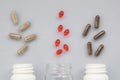 Medicinal capsule spill out of a three plastic bottles on a ligh Royalty Free Stock Photo