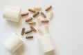 Medicinal capsule spill out of a three plastic bottles Royalty Free Stock Photo