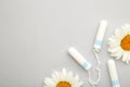 Medicinal chamomile flower and menstrual sanitary tampon. Woman critical days, gynecological menstruation cycle