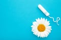 Medicinal chamomile flower and menstrual sanitary tampon. Woman critical days, gynecological menstruation cycle
