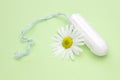 Medicinal chamomile flower and menstrual sanitary tampon. Woman critical days, gynecological menstruation cycle. Menstruation sani