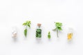 Medicinal herb in bottles on white background top view copyspace