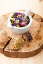 Medicinal herbs and flowers in a glass mortar. Royalty Free Stock Photo