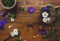 Medicinal herbs and strawberries, decoction of chamomile, yarrow and mint, tea. on a wooden background